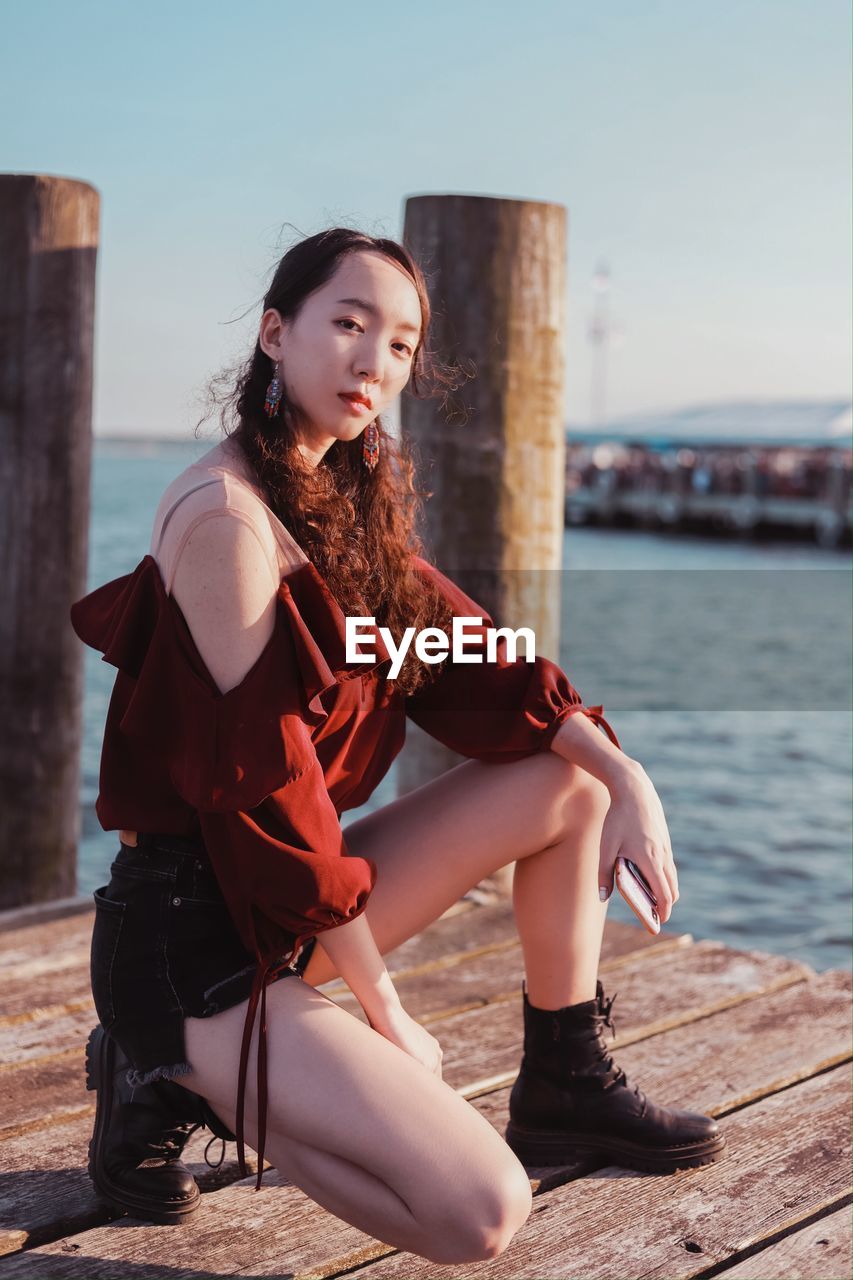 YOUNG WOMAN SITTING IN WATER