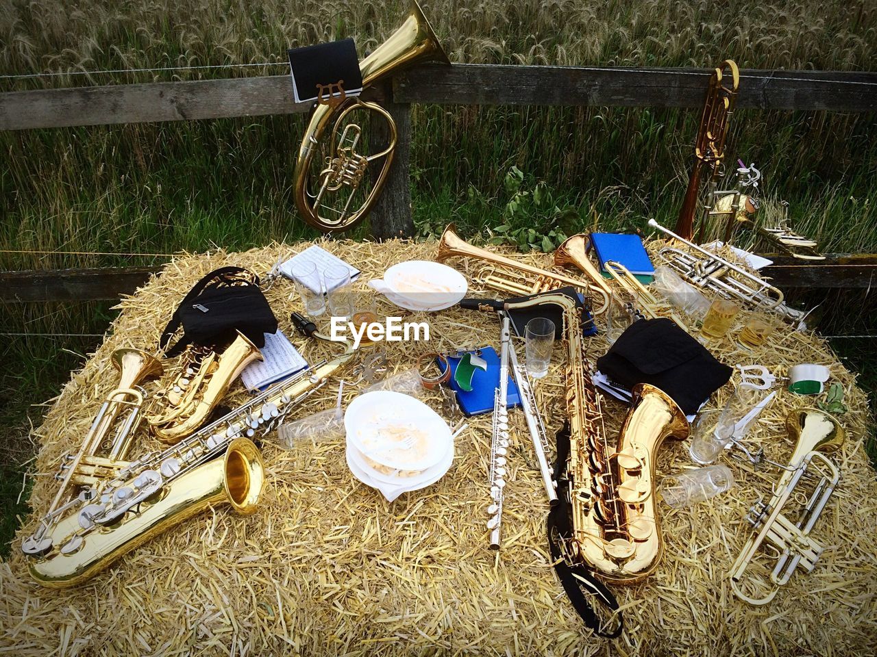 High angle view of musical instruments on hay at field