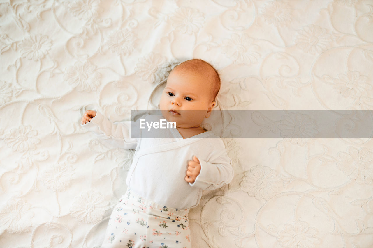 High angle view of girl sleeping on bed