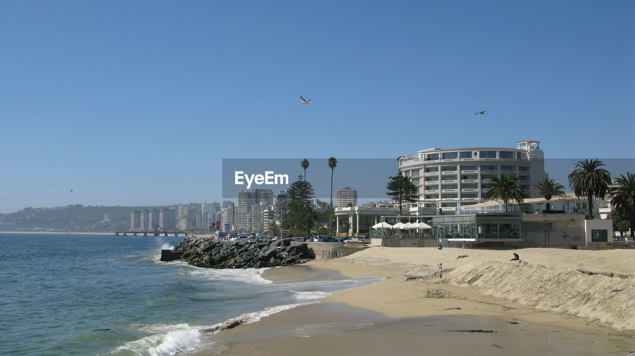 View of beach and buildings against sky