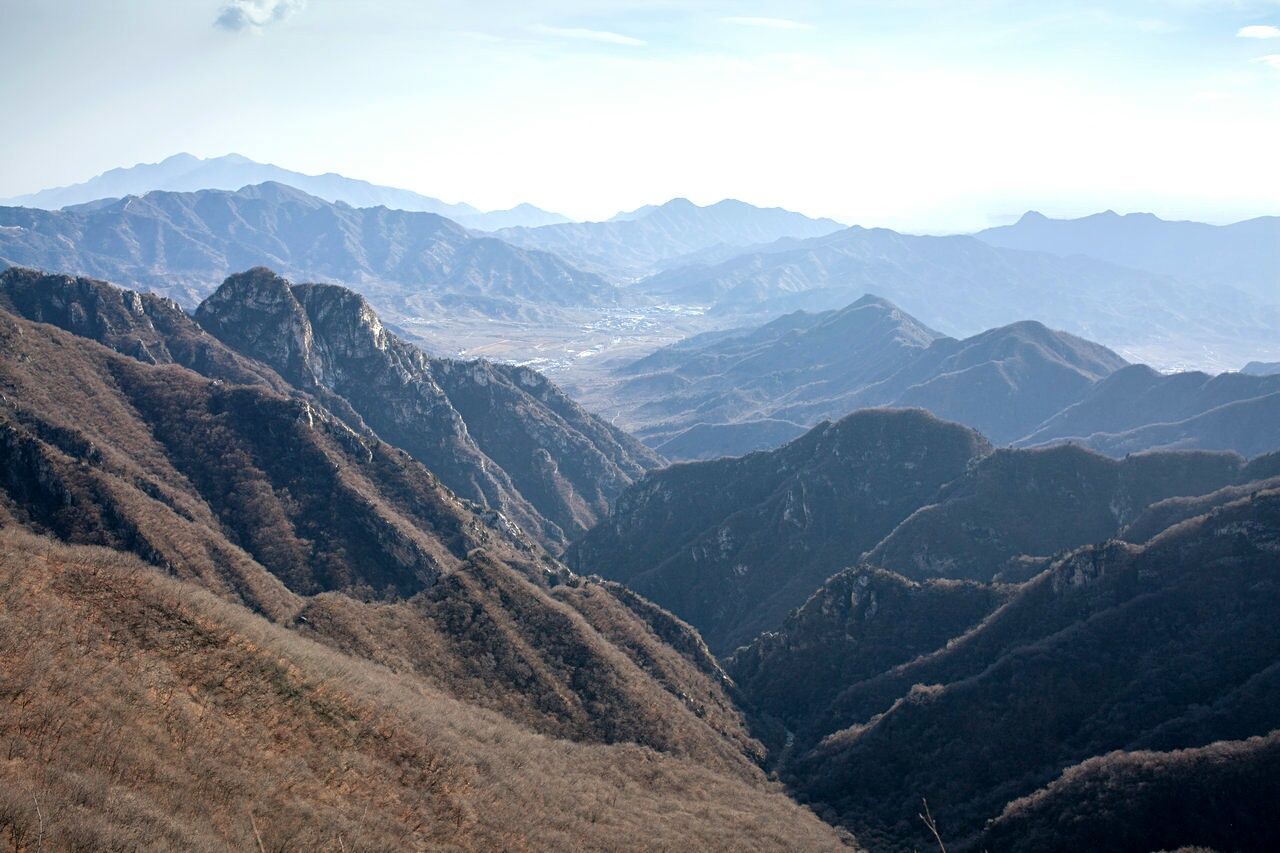 Scenic view of mountains against cloudy sky