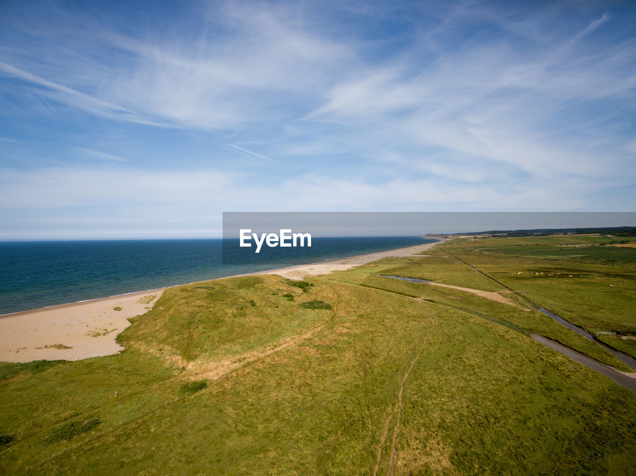 Scenic view of beach against sky