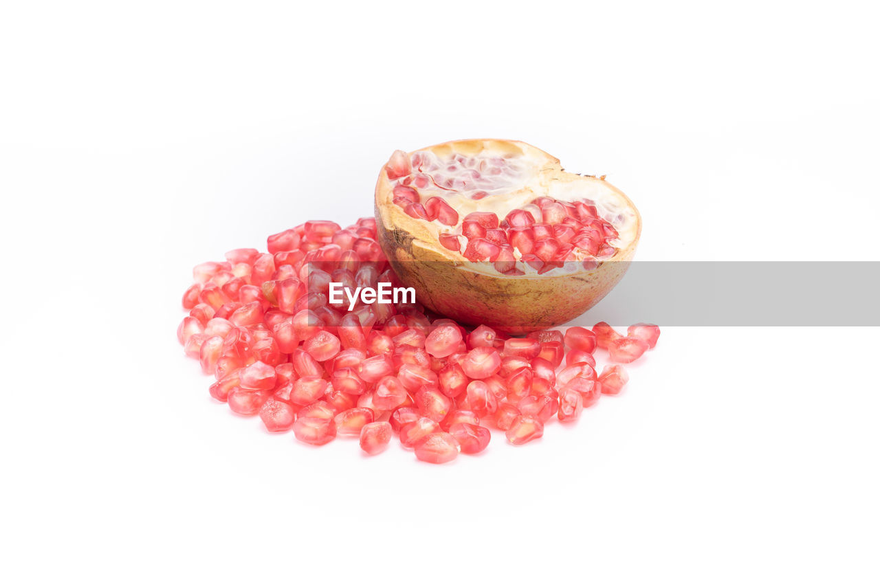 CLOSE-UP OF FRESH PINK STRAWBERRIES OVER WHITE BACKGROUND