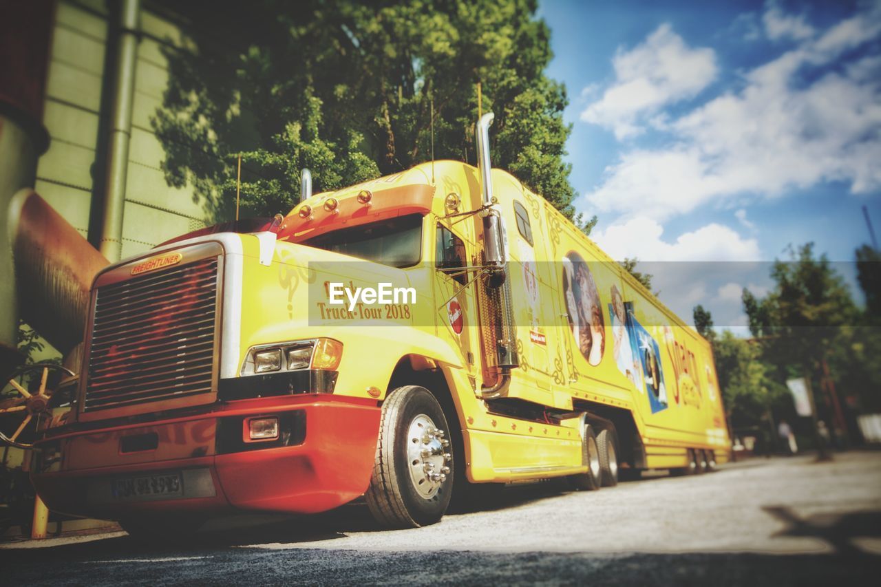 VIEW OF YELLOW TRUCK ON ROAD