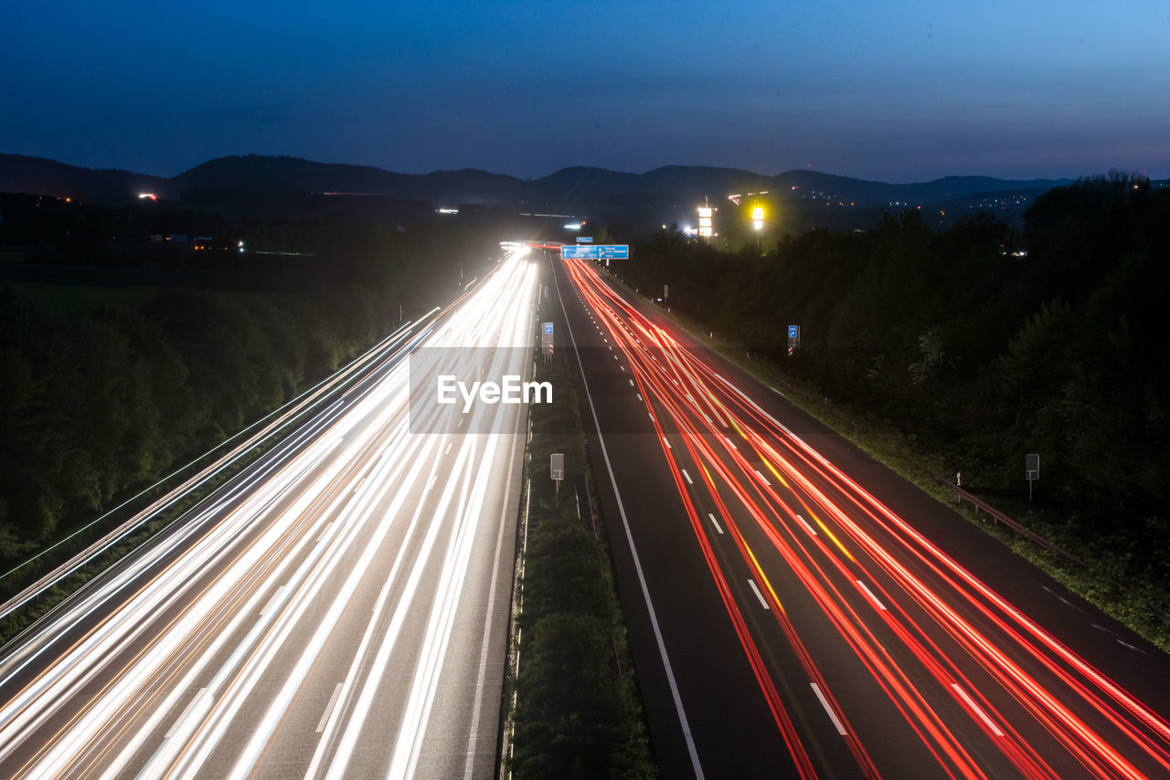 High angle view of light trails on road at night