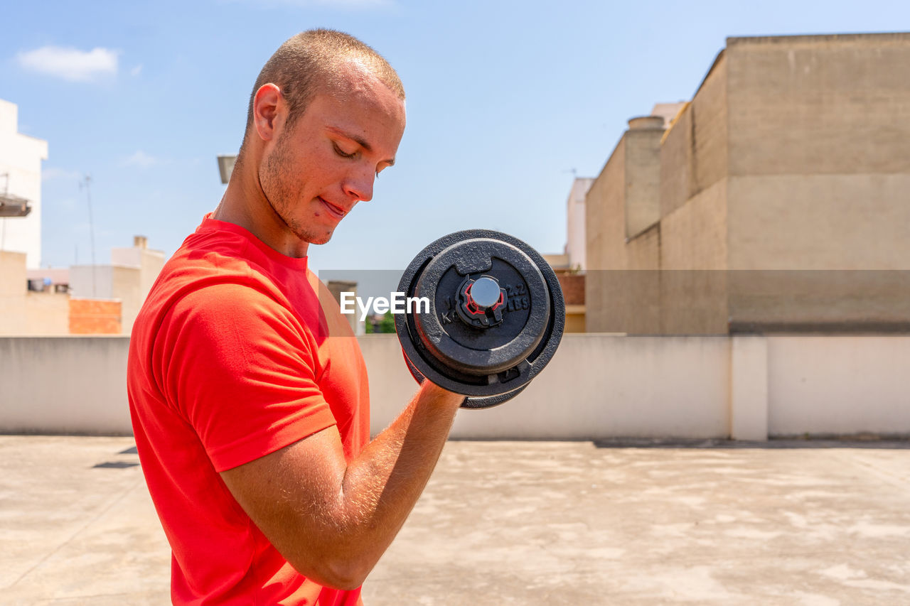 FULL LENGTH OF MAN HOLDING CAMERA