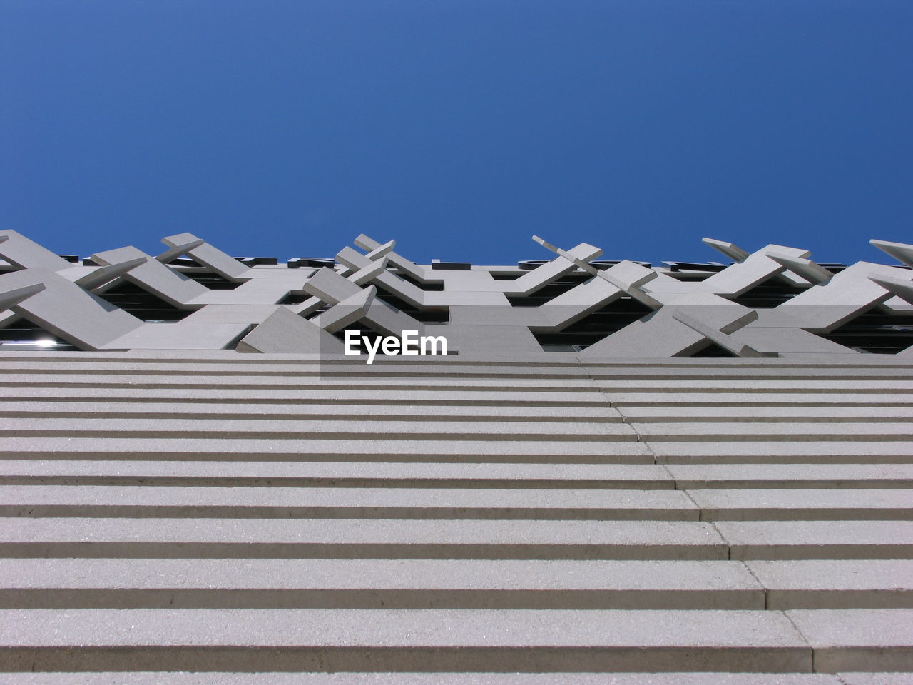 Low angle view of building against clear blue sky