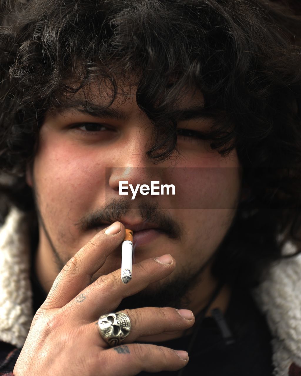 Close-up portrait of man smoking cigarette