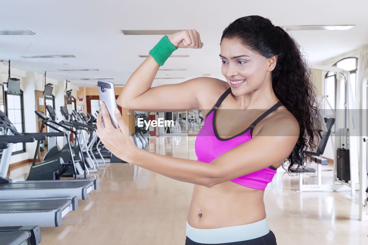 Confident woman exercising in gym