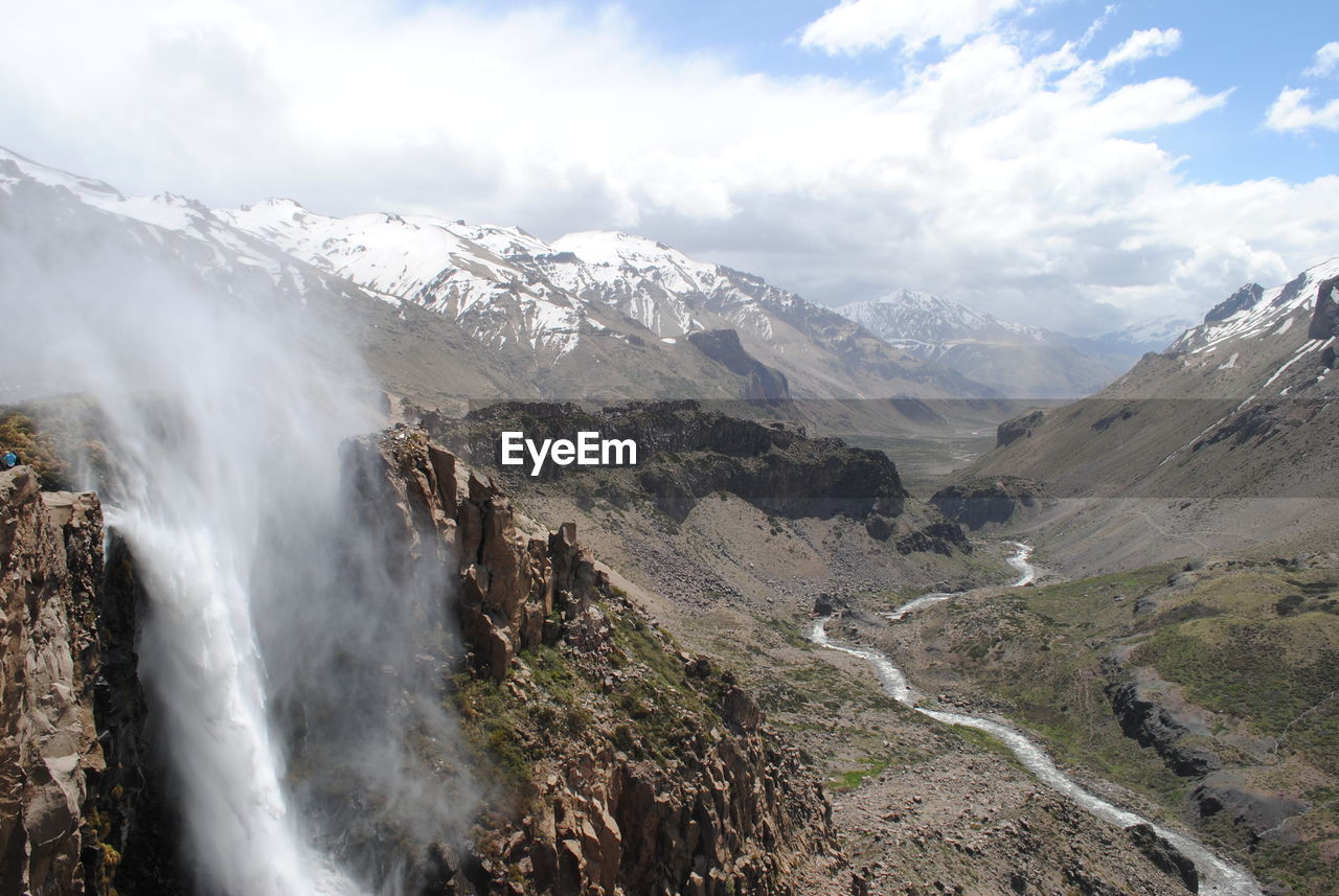 Scenic view of waterfall against sky