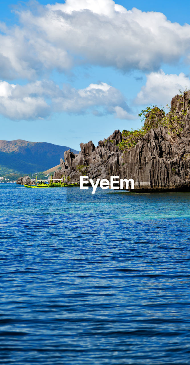 SCENIC VIEW OF SEA AND ROCKS AGAINST SKY