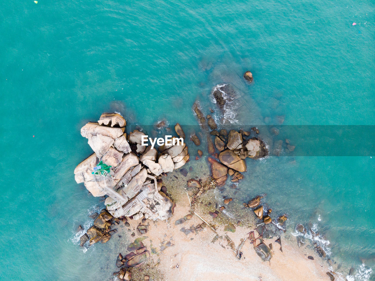 Aerial view of rocks by sea