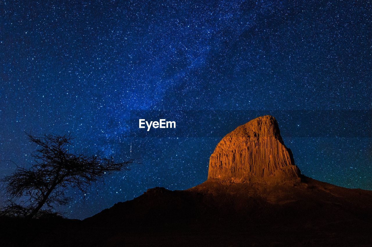Rock formations against sky at night