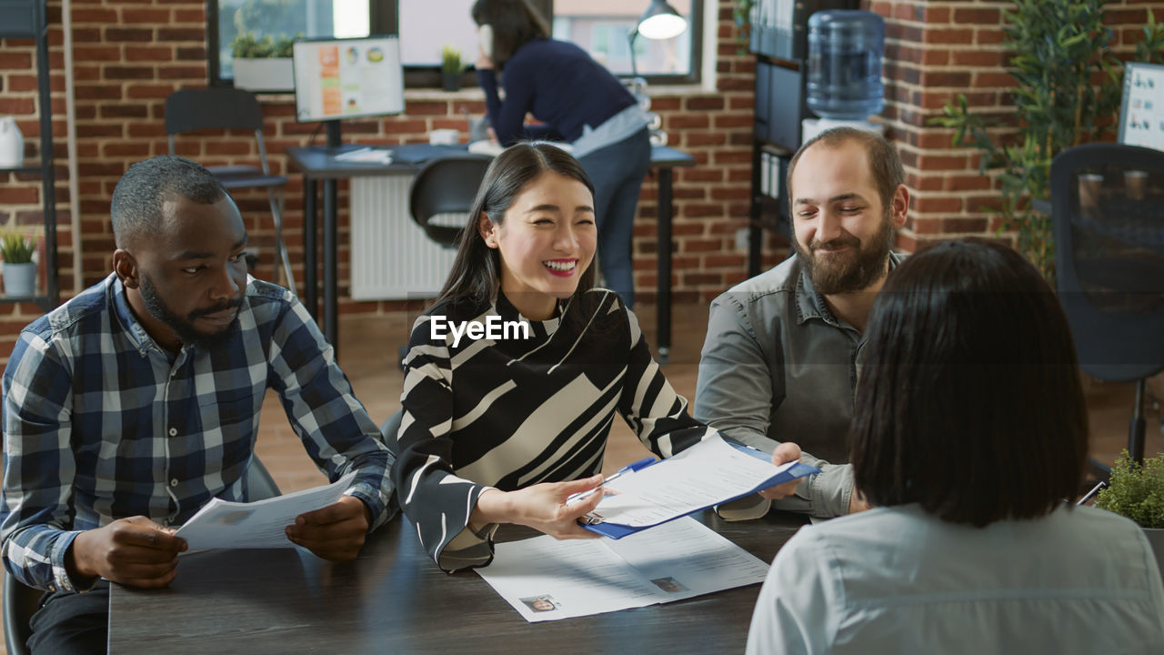 Smiling business colleagues working in office