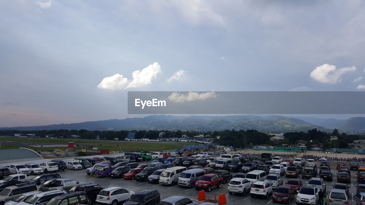 CARS ON MOUNTAINS AGAINST SKY