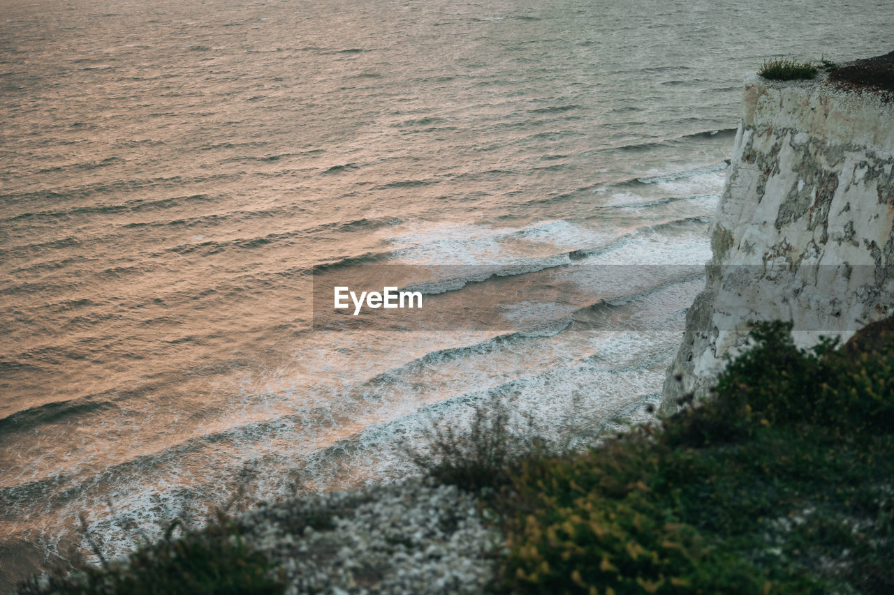 High angle view of waves hitting seven sisters chalk cliffs in east sussex, uk.