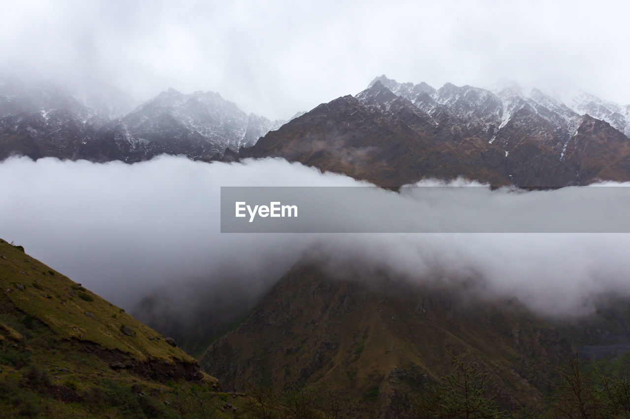 Scenic view of mountains against sky during winter