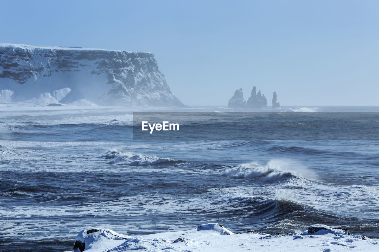 Wide lens capture of three pinnacles of vik, south iceland in wintertime