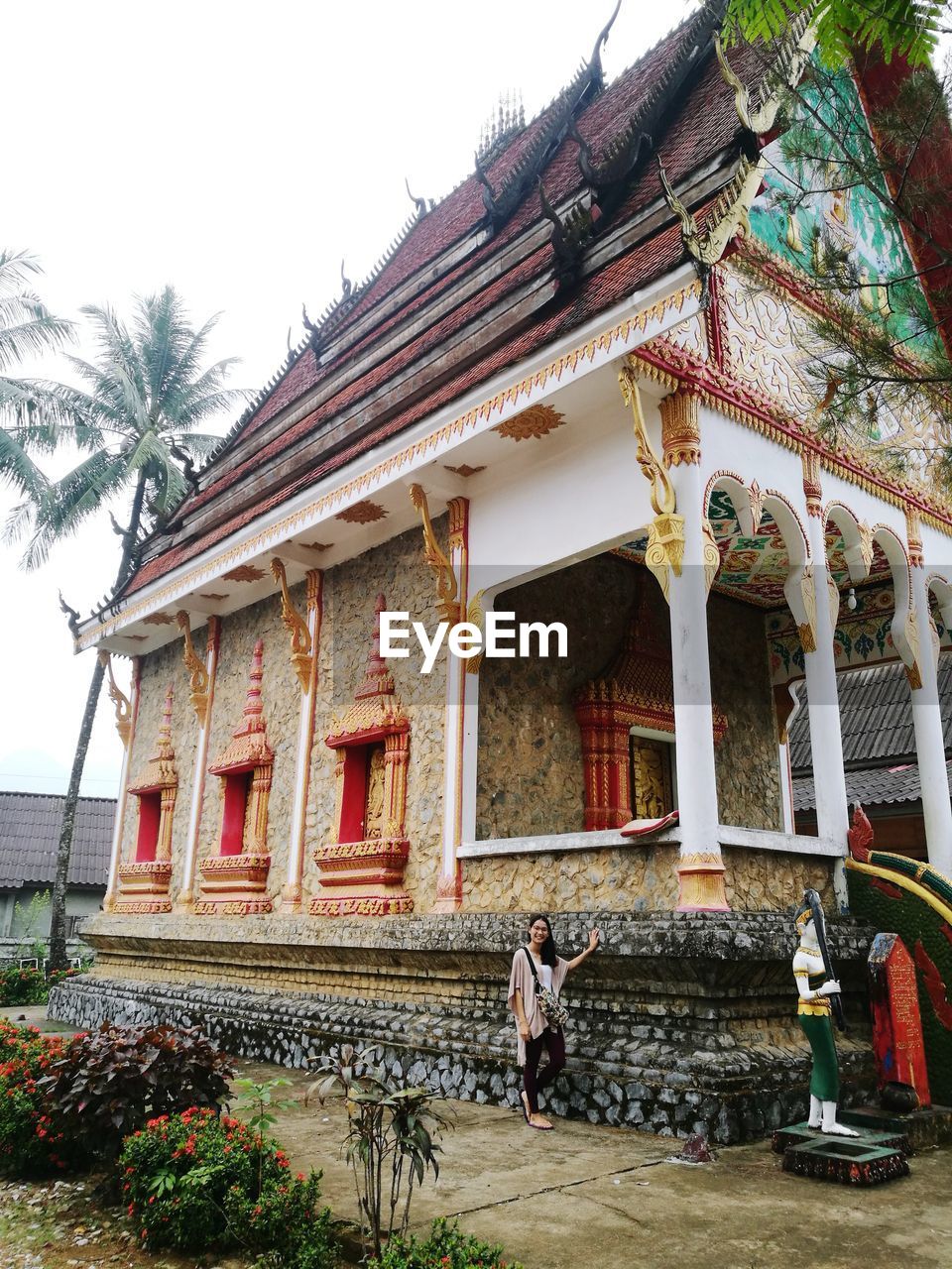 MAN OUTSIDE TEMPLE AGAINST SKY