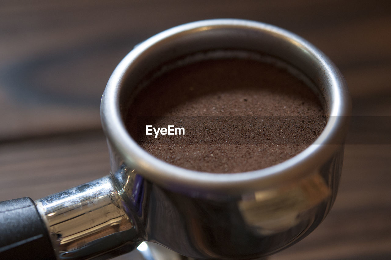 Close-up of ground coffee in filter on table