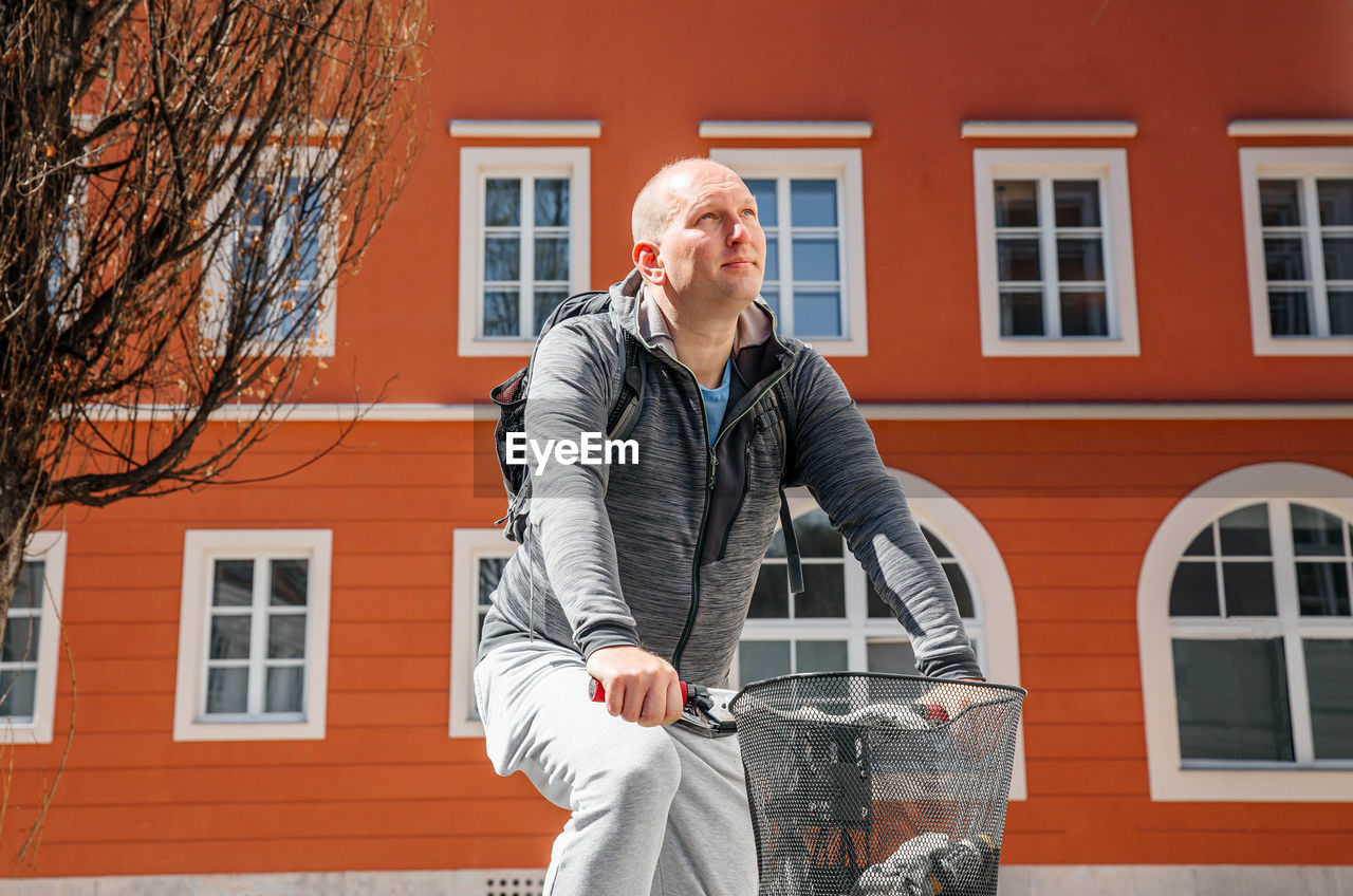 Portrait of a handsome hipster man. a man in a big city cycling down the street on a bicycle