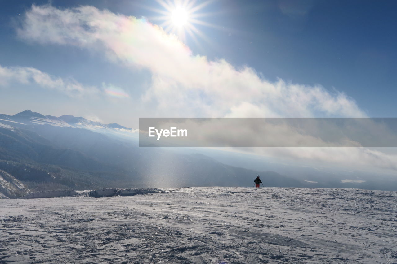 Man walking on landscape against sky