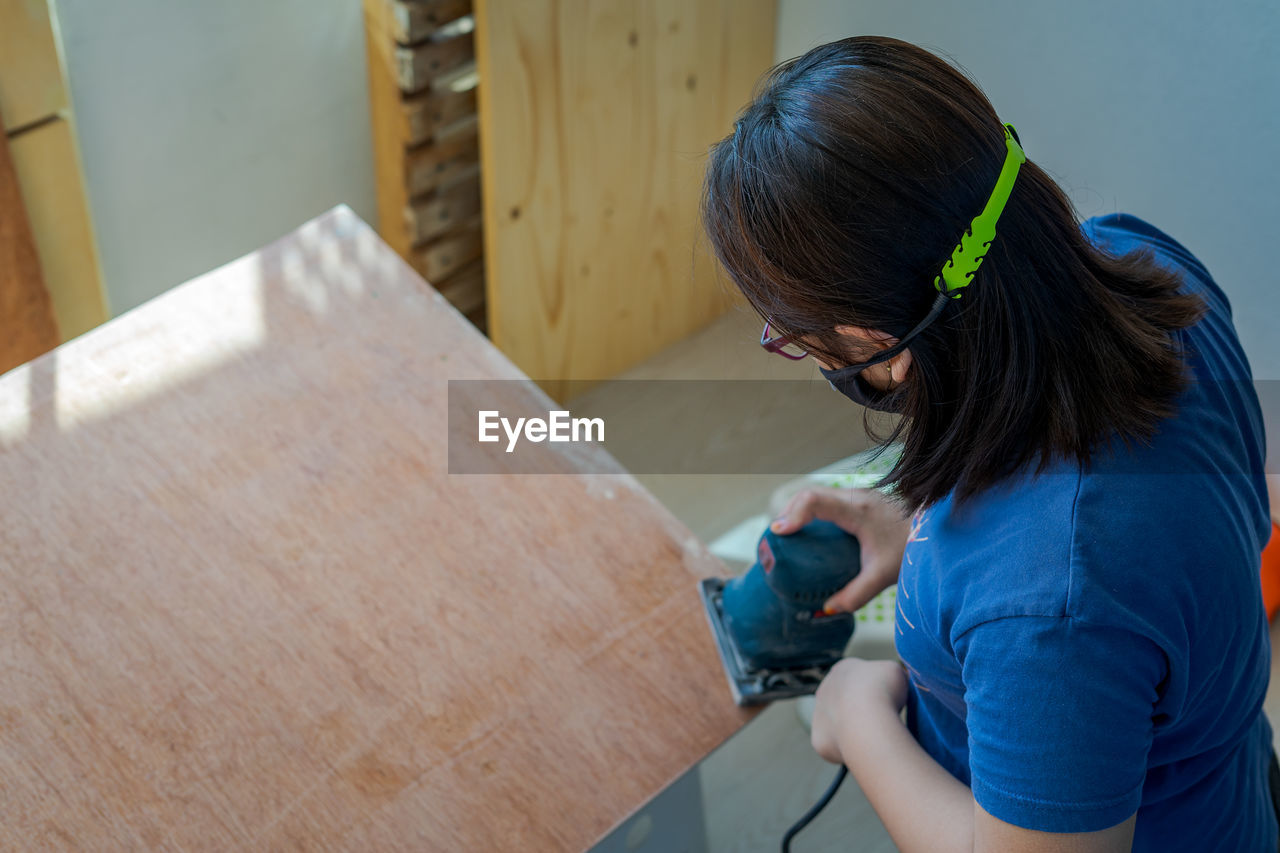 Woman working on wood