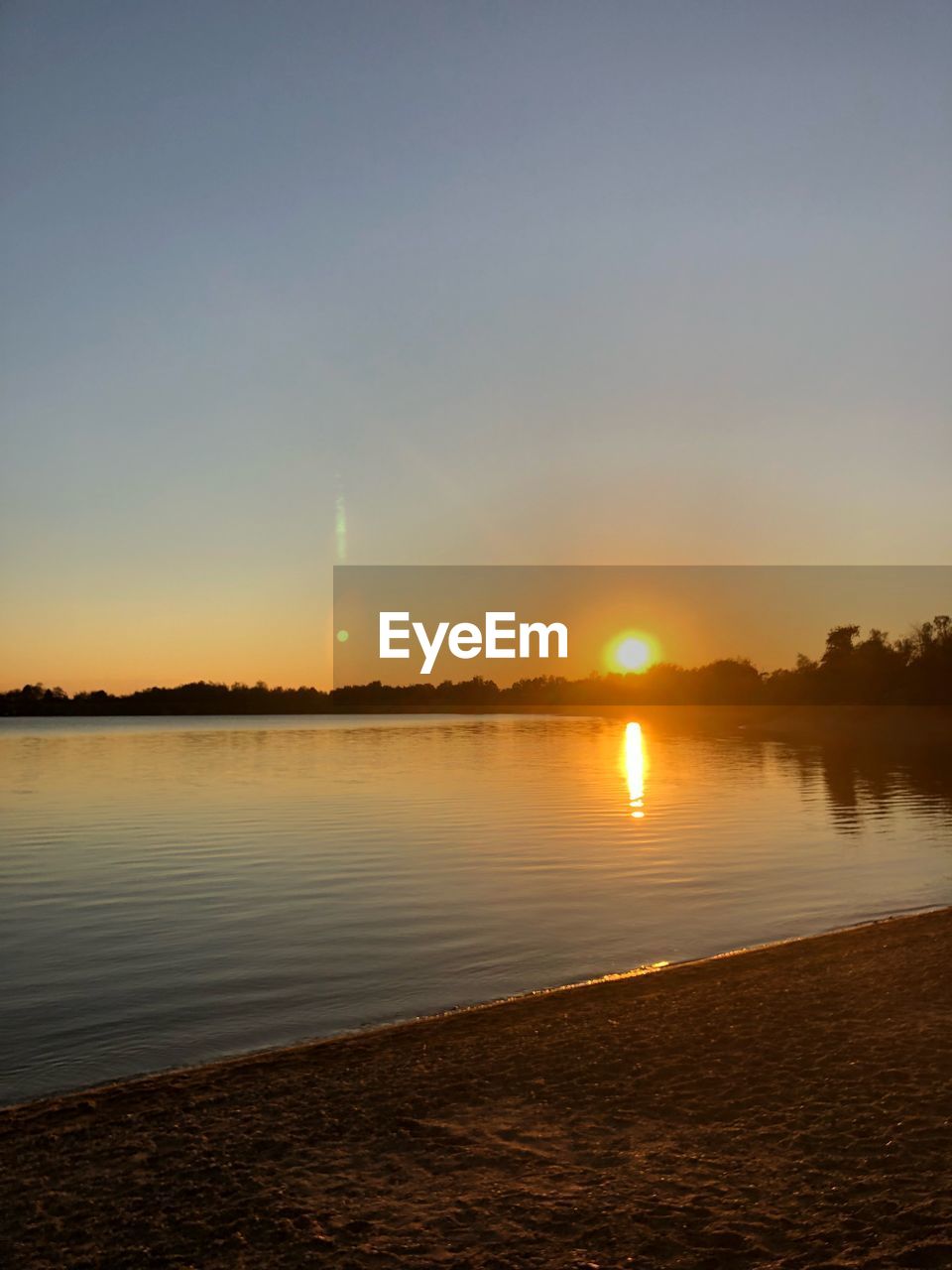 SCENIC VIEW OF SUNSET OVER CALM LAKE