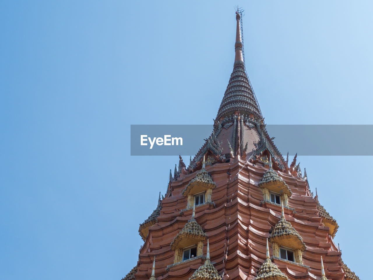 Low angle view of temple building against clear blue sky