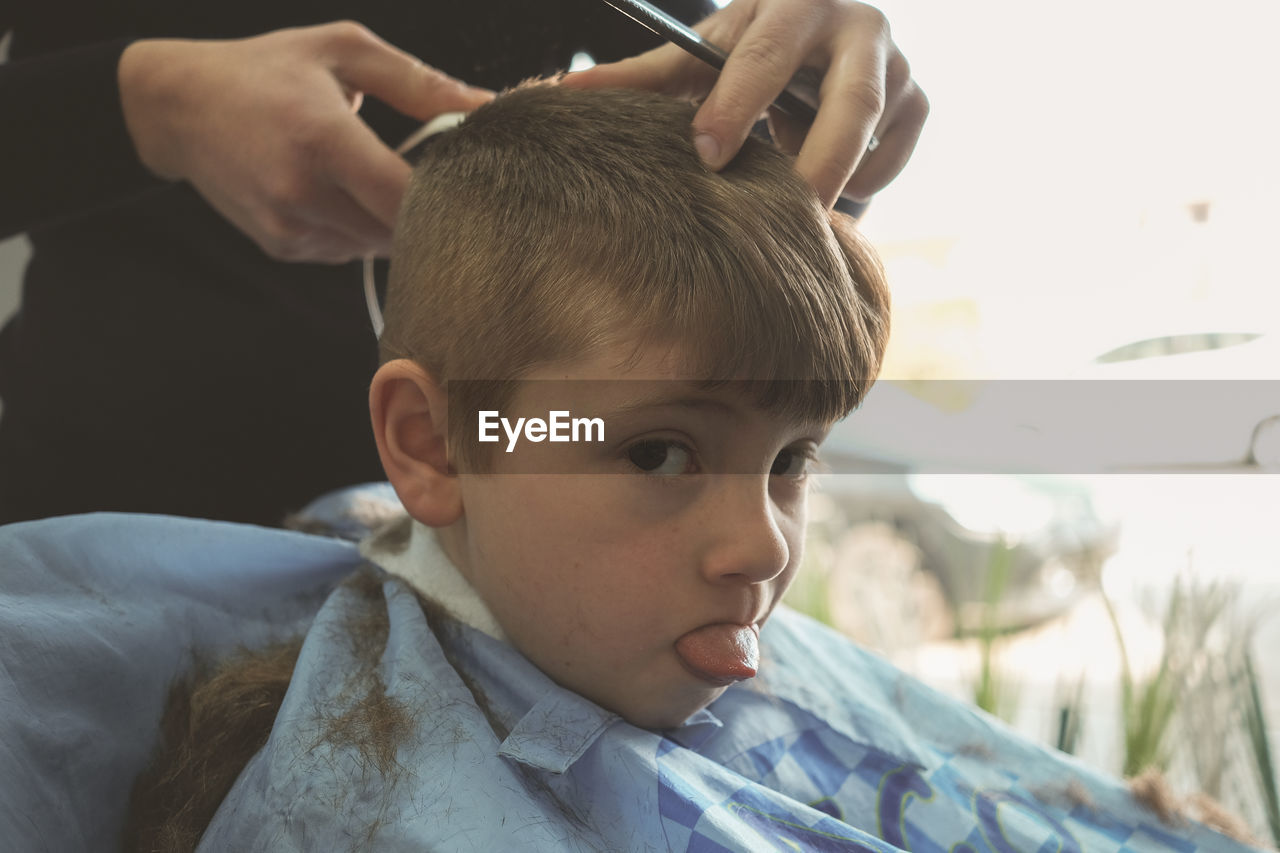 Close-up of boy at hairdresser's