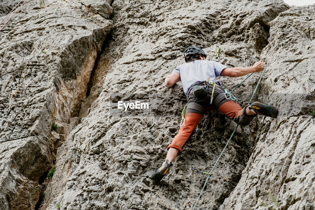 rear view of man walking on rock