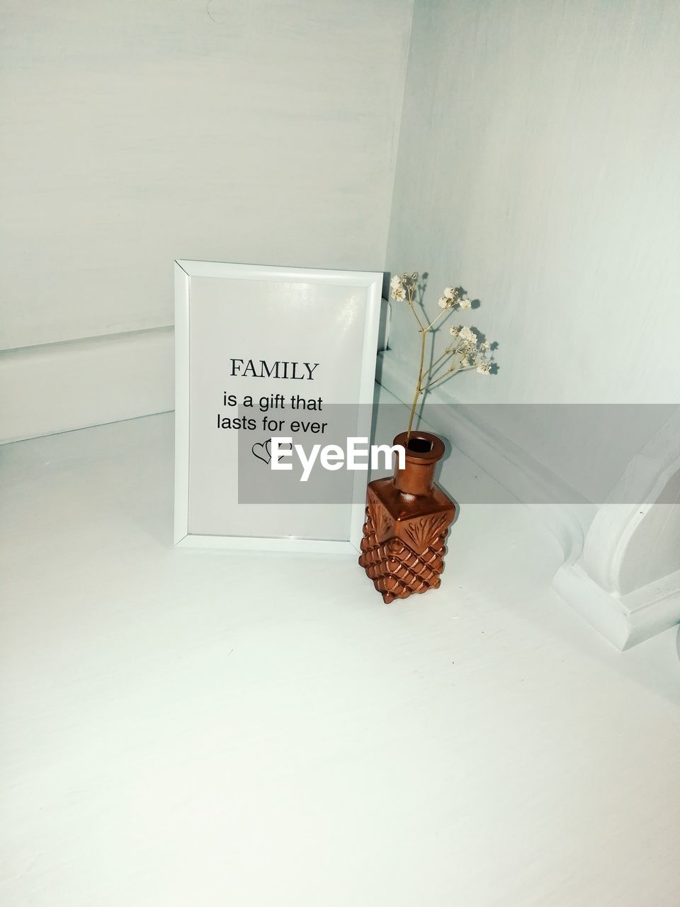 High angle view of picture frame and vase on floor at home