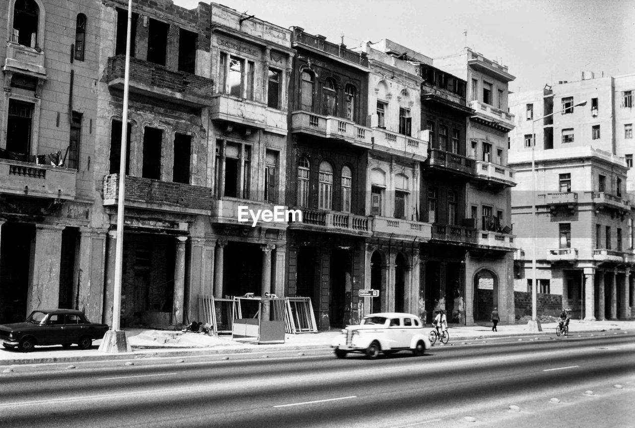 Cars on street by buildings in city