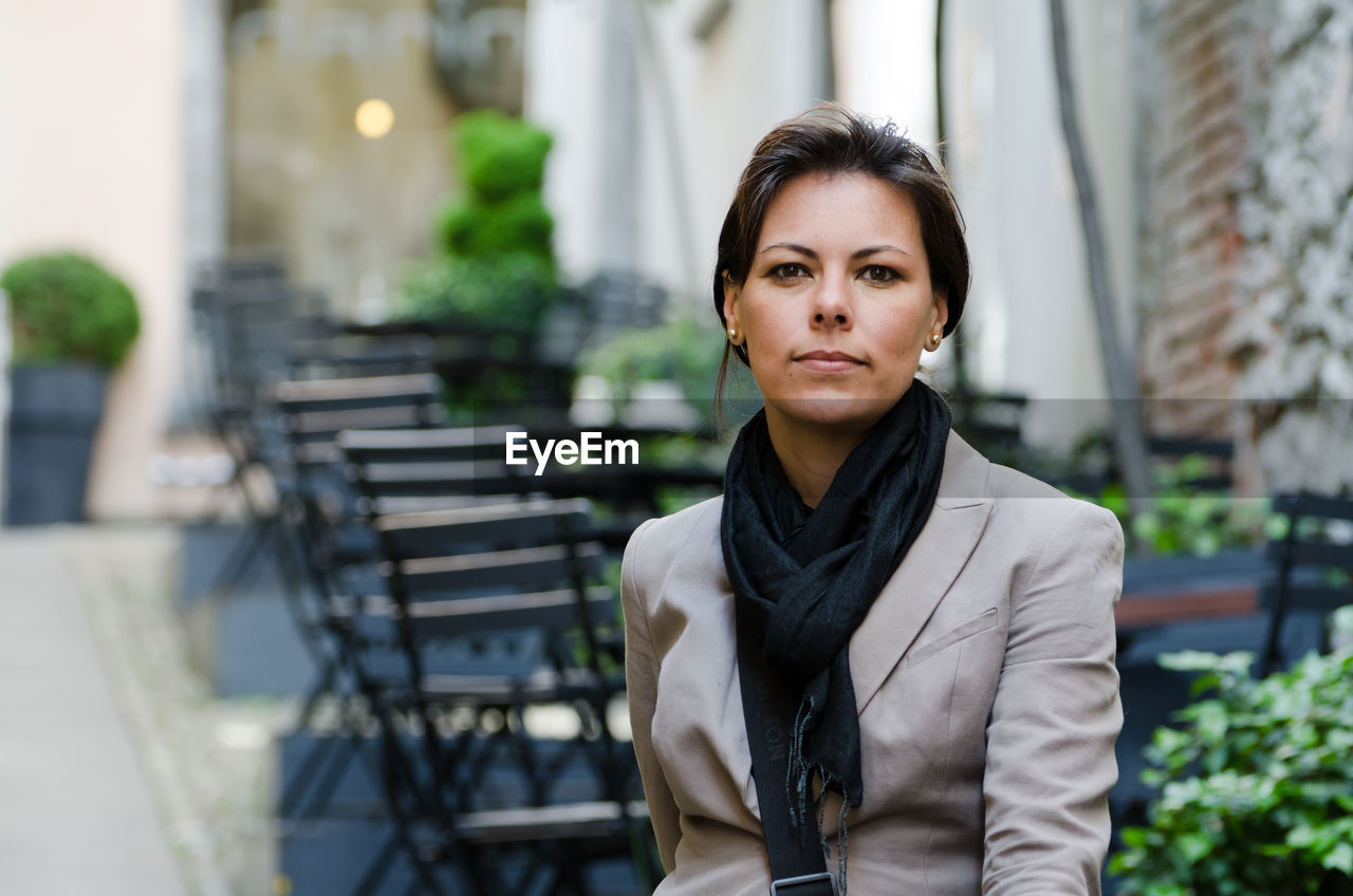 Portrait of young woman in city