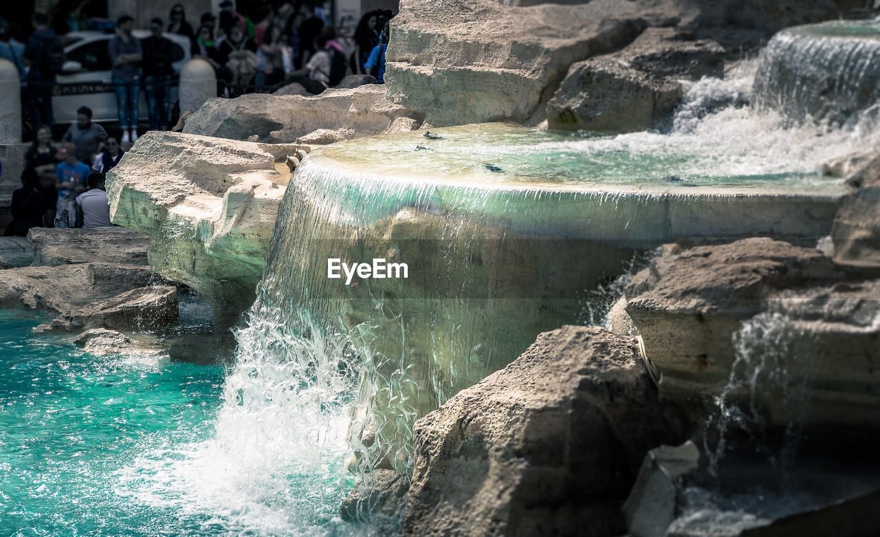 View of flowing water against rocks