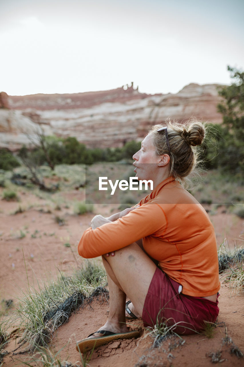 Profile portrait of a female desert hiker making a fish face