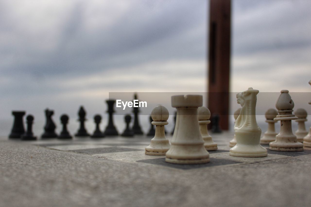 Close-up of chess pieces against sky