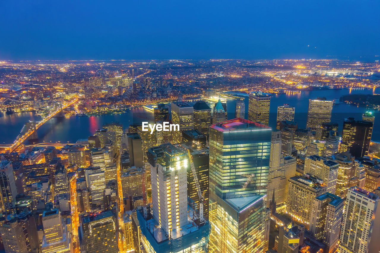 high angle view of illuminated cityscape against sky at night