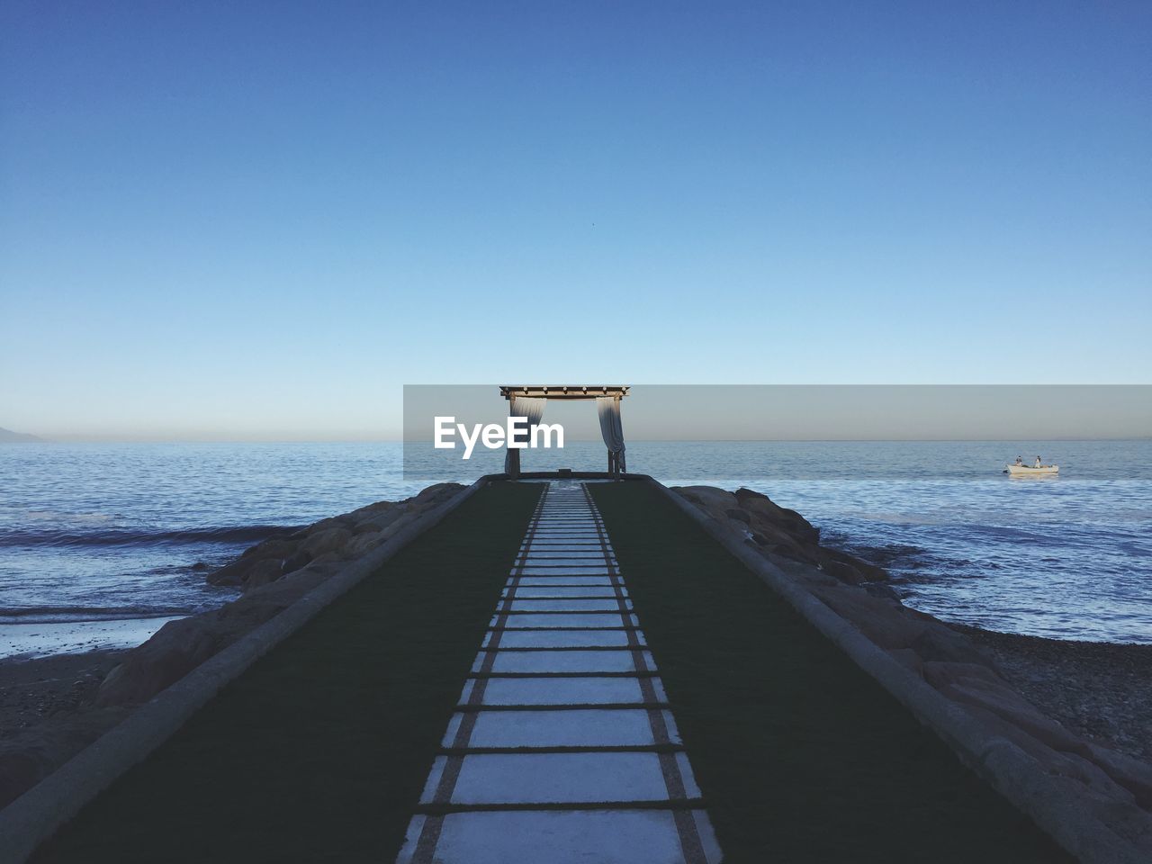 Scenic view of sea against clear blue sky