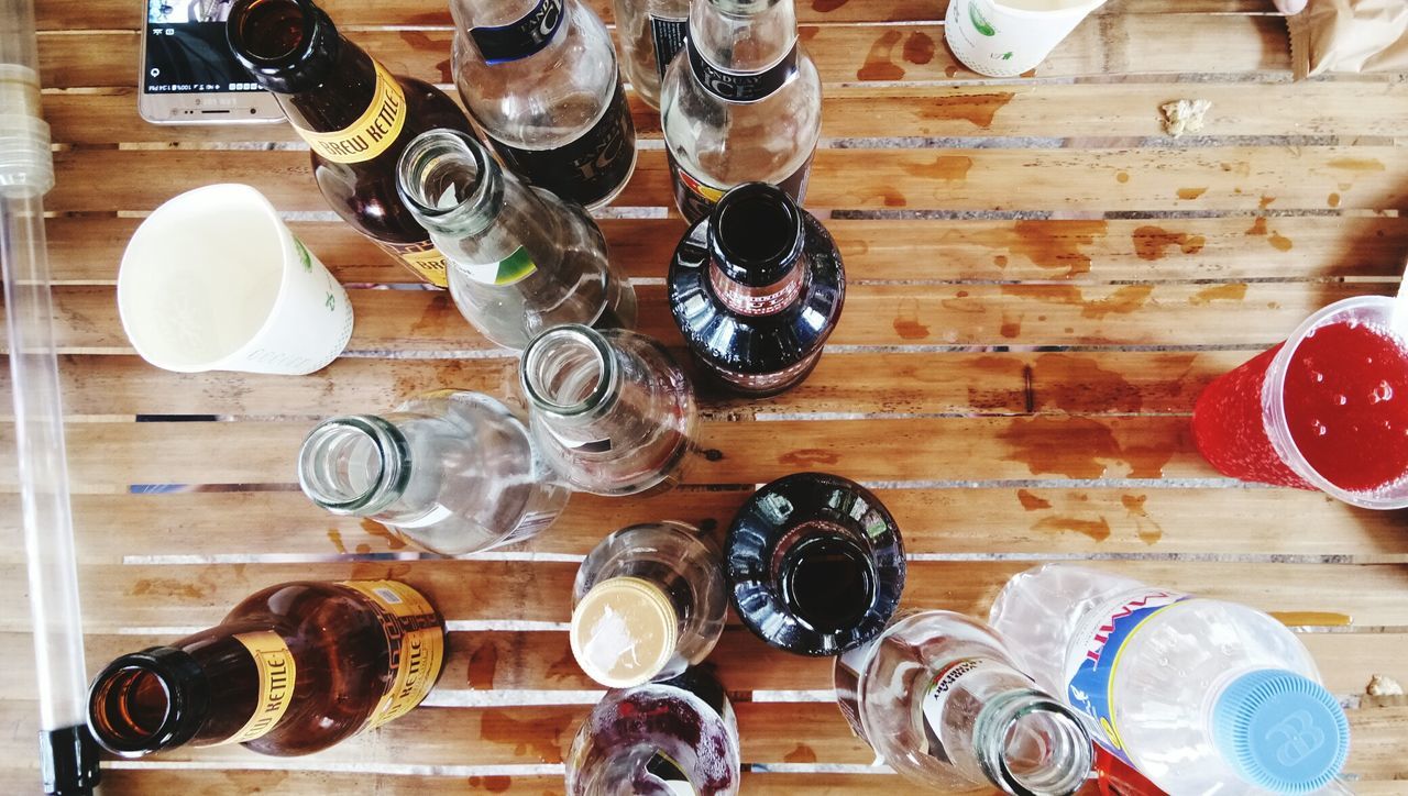 DIRECTLY ABOVE SHOT OF BOTTLES ON TABLE