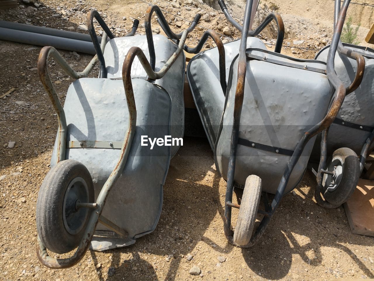 High angle view of old wheelbarrows on field