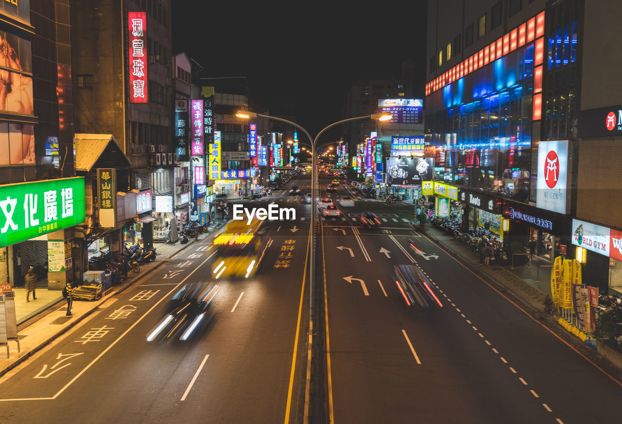 Light trails on road in city at night