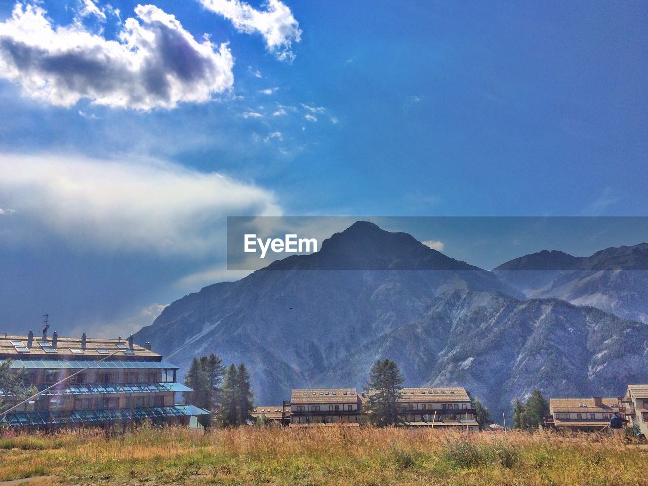 Scenic view of field and mountains against sky