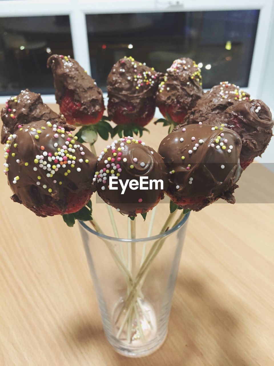 Close-up of chocolate lollipops in glass