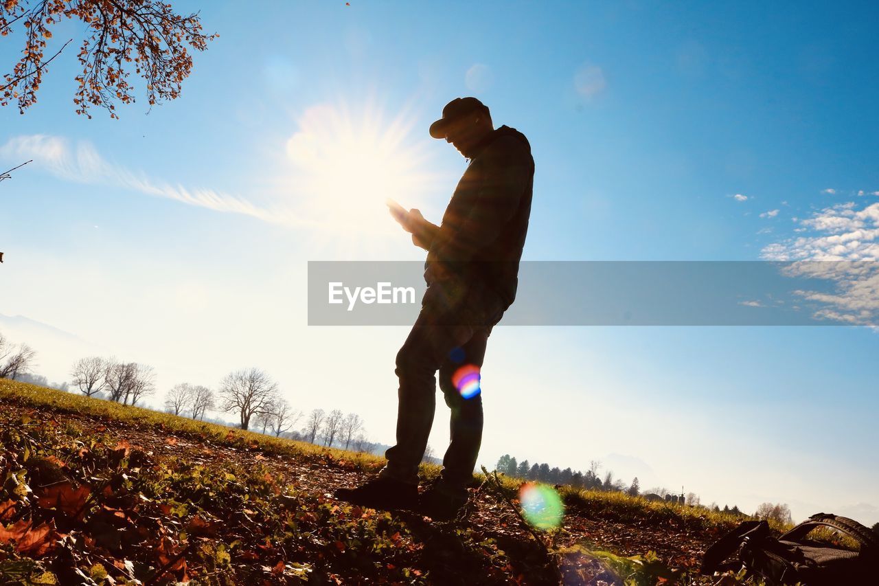 Man standing on field against sky