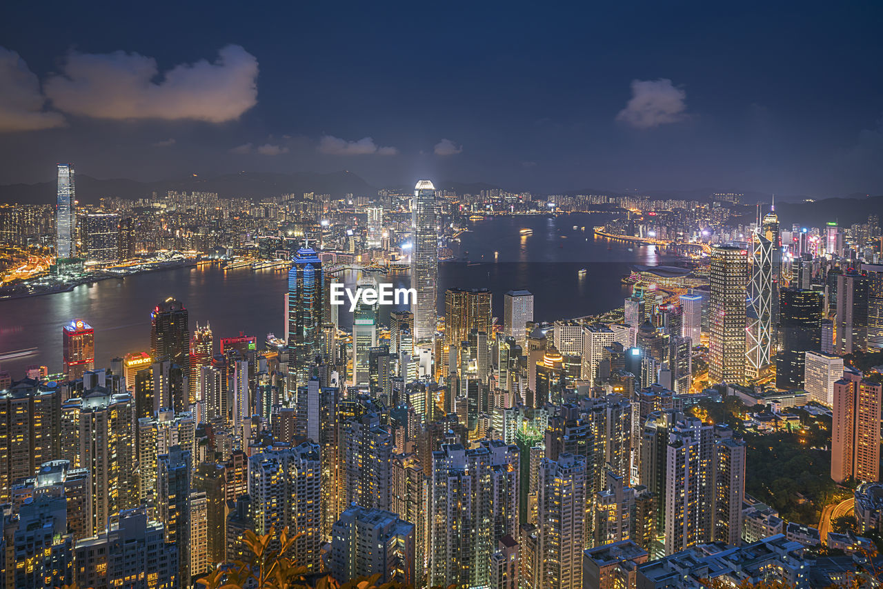 Aerial view of illuminated cityscape against sky at night