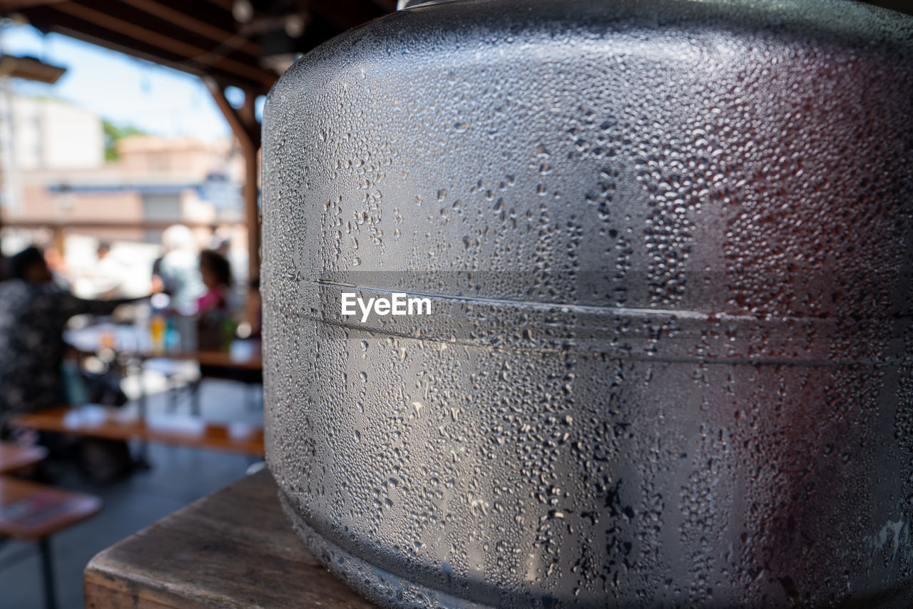 CLOSE-UP OF WET GLASS IN CONTAINER