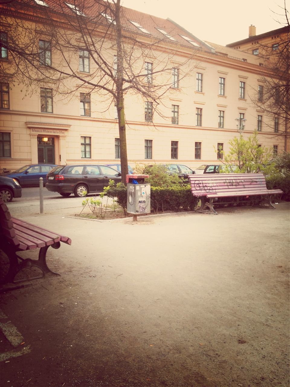 Cars on street by building