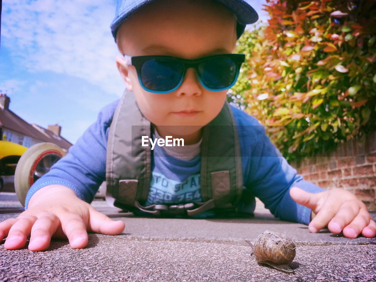 Child looking at a snail