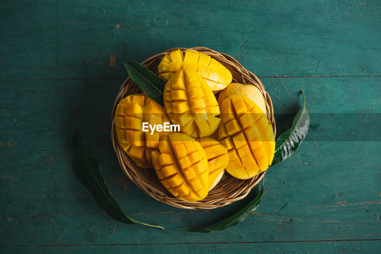 HIGH ANGLE VIEW OF YELLOW FRUITS ON TABLE